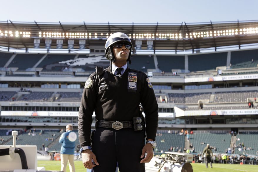 A Philadelphia police officer stands posted inside Lincoln Financial Field during warm-ups before an NFL football game between the Philadelphia Eagles and the Miami Dolphins, Sunday, Nov. 15, 2015, in Philadelphia. The NFL said it had been in contact with the Department of Homeland Security and the FBI and planned increased security inside and outside stadiums on Sunday. League officials discouraged fans from bringing bags.(AP Photo/Matt Rourke)