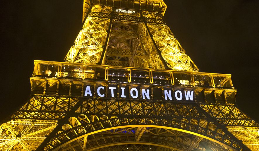 The Eiffel Tower lights up Sunday with the slogan &quot;Action Now&quot; for the COP 21, United Nations Climate Change Conference in Paris. Negotiators adopted a draft climate agreement Saturday that was cluttered with brackets and competing options, leaving ministers with the job of untangling key sticking points in what is envisioned to become a lasting, universal pact to fight global warming. (Associated Press)
