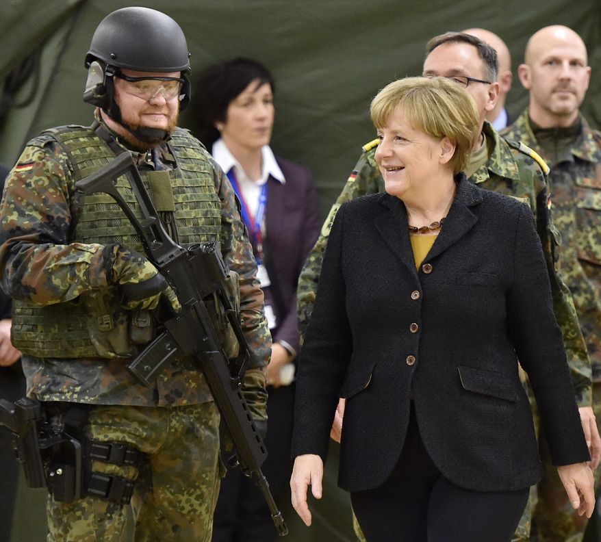 German chancellor Angela Merkel passes a soldiers during a visit of the German Army medical service in Leer, northern Germany, Monday, Dec. 7, 2015. Germany's parliament voted last week to send military support in the fight against Islamic State militants in Syria. (AP Photo/Martin Meissner) ** FILE **