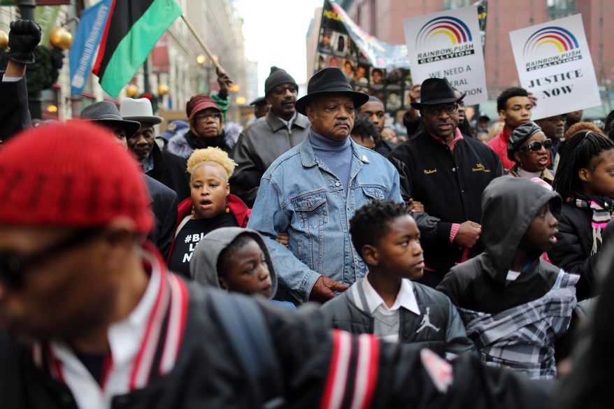 Rev. Jesse Jackson and the Rainbow PUSH Coalition lead a protest through the Loop in Chicago on Sunday, Dec. 6, 2015, in response to the Laquan McDonald shooting and continuing Chicago Police investigation. About 200 protesters are demonstrating following the release of documents showing that police officers' accounts of the 2014 killing of McDonald differed greatly from what was captured on dashcam video. (Brian Cassella/Chicago Tribune via AP)