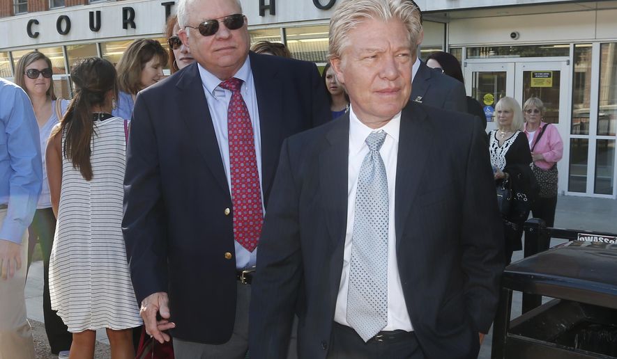 FILE - In this Monday, July 13, 2015 file photo, Robert Bates, left, leaves the Tulsa County Courthouse following his arraignment, with his attorney, Clark Brewster, right, in Tulsa, Okla. A second judge Monday, Dec. 7, 2015 removed herself from the case of the former Oklahoma volunteer sheriff’s deputy charged with second-degree manslaughter in an unarmed man’s shooting death. (AP Photo/Sue Ogrocki, File)