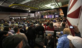 An overflow crowed fills the hangar deck of the USS Yorktown as Republican presidential candidate, businessman Donald Trump, speaks during a rally coinciding with Pearl Harbor Day at Patriots Point aboard the aircraft carrier USS Yorktown in Mt. Pleasant, S.C., Monday, Dec. 7, 2015. (AP Photo/Mic Smith)