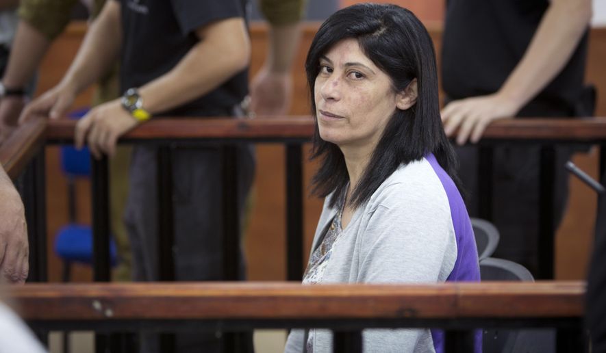 File - This Thursday, May 21, 2015 role photo shows Palestinian Parliament member  Khalida Jarrar of the Popular Front for the Liberation of Palestine (PFLP) attending a court session at the Israeli Ofer military base near the West Bank city of Ramallah.  Israeli military said  it has sentenced Jarrear to 15 months in prison after convicting her of belonging to an illegal organization and incitement.  (AP Photo/Majdi Mohammed, File)