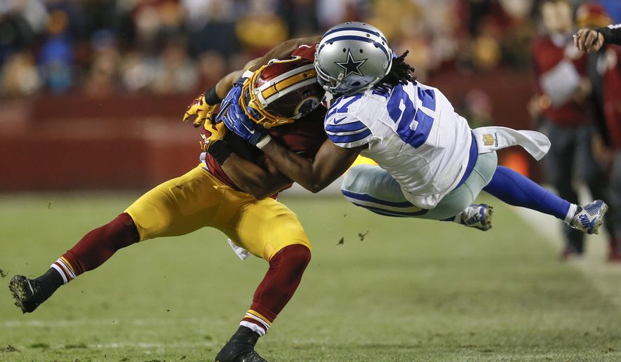 Dallas Cowboys free safety J.J. Wilcox (27) pulls down Washington Redskins running back Chris Thompson (25) during the second half of an NFL football game in Landover, Md., Monday, Dec. 7, 2015. (AP Photo/Patrick Semansky)
