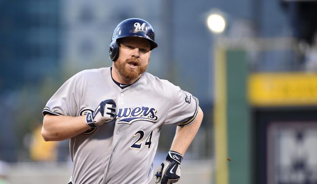 FILE - In this Sept. 11, 2015, file photo, Milwaukee Brewers&#x27; Adam Lind trots around the bases after hitting a homerun during a game against the Pittsburgh Pirates, in Pittsburgh. The busy Seattle Mariners have acquired first baseman Adam Lind from the Milwaukee Brewers for three young minor league pitchers. The team announced the trade Wednesday, Dec. 9, 2015,  at the winter meetings. (AP Photo/Fred Vuich, File) **FILE**