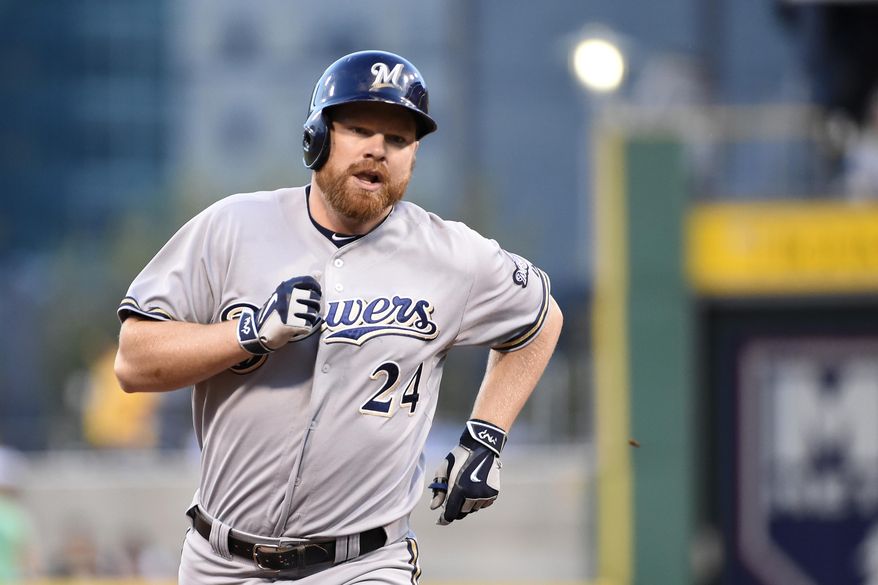 FILE - In this Sept. 11, 2015, file photo, Milwaukee Brewers' Adam Lind trots around the bases after hitting a homerun during a game against the Pittsburgh Pirates, in Pittsburgh. The busy Seattle Mariners have acquired first baseman Adam Lind from the Milwaukee Brewers for three young minor league pitchers. The team announced the trade Wednesday, Dec. 9, 2015, at the winter meetings. (AP Photo/Fred Vuich, File) **FILE**