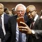 Democratic presidential candidate, Sen. Bernie Sanders, I-Vt., center, poses for a selfie with Rev. Carlton Lee at the Freddie Gray Empowerment Center in Baltimore, Tuesday, Dec. 8, 2015, after taking a walking tour of Gray&#39;s neighborhood and meeting with African-American civic and religious leaders in Baltimore, Tuesday, Dec. 8, 2015. (AP Photo/Patrick Semansky) ** FILE **