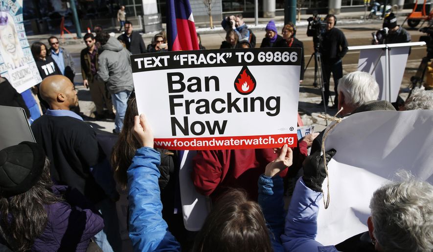 An activist waves a placard calling for the ban of fracking during a Feb. 24, 2015, news conference outside the Colorado Convention Center in Denver as the Oil and Gas Task Force meets inside the facility to put the final touches on recommendations for Colorado Gov. John Hickenlooper to consider in the settlement of disputes over oil and gas well development. (Associated Press) **FILE**