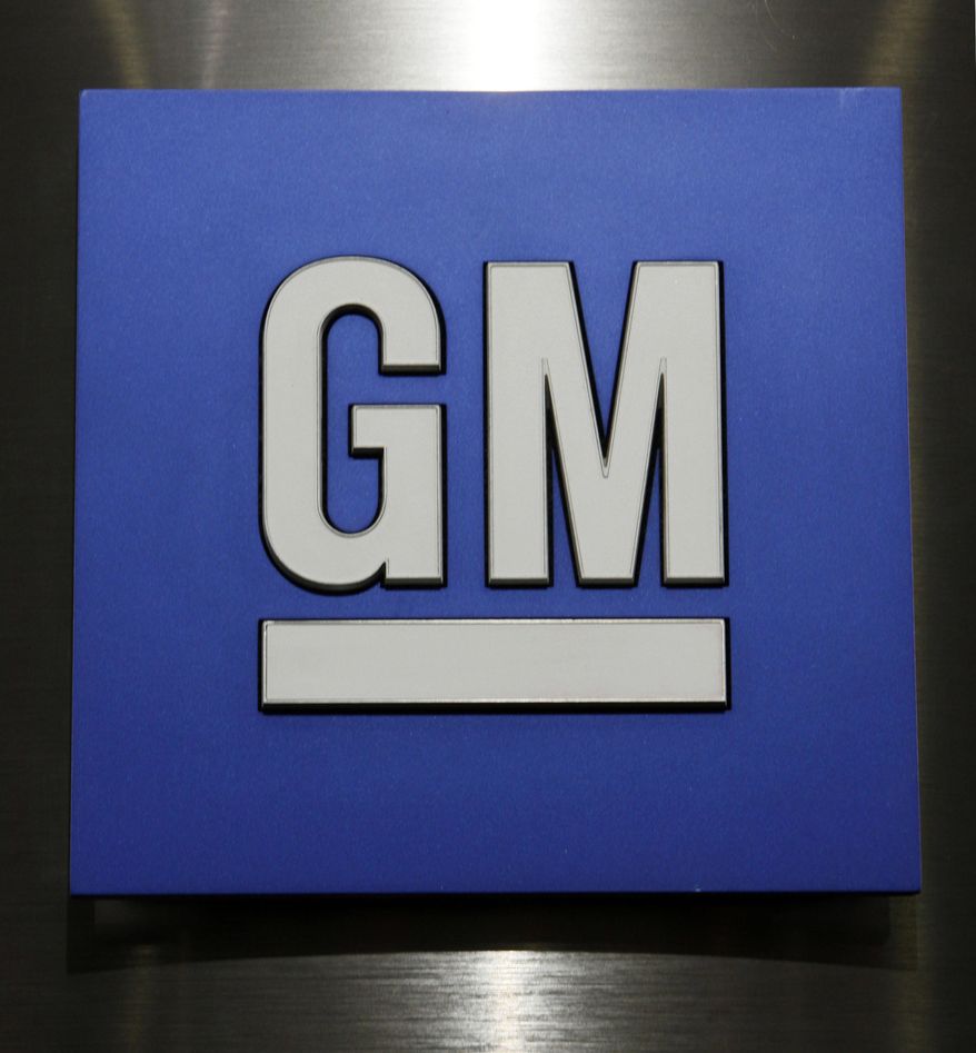 FILE - This Jan. 25, 2010, file photo, shows a General Motors Co. logo during a news conference in Detroit. General Motors has decided to replace several key engine parts to stop oil leaks that have caused more than 1,300 fires and four recalls of older cars. But the parts aren’t available yet, and GM is still recommending that the cars be parked outside until they can be repaired. (AP Photo/Paul Sancya, File)