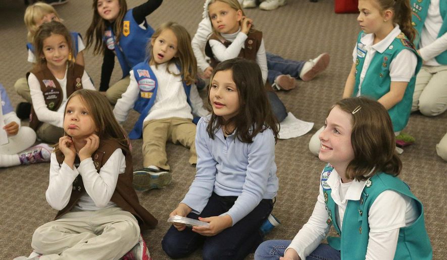FILE - In this Thursday, Jan. 8, 2015 file photo, girls listen during the Girl Scout Troop 582's cookie training session at Beach Vineyard Church in Panama City Beach, Fla. As the Girl Scouts' membership continues a sharp decline, its leaders are betting on technology to reverse the trend, including a major expansion of its year-old program enabling Girl Scout cookies to be sold via mobile apps and the girls’ personalized websites. The Digital Cookie upgrade, announced on Tuesday, Dec. 8, 2015 comes amid persisting challenges for the 103-year-old organization. (Heather Leiphart/The News Herald via AP)