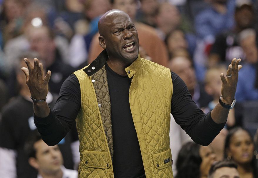 Charlotte Hornets owner Michael Jordan reacts to a call in the first half of an NBA basketball game against the Miami Heat in Charlotte, N.C., Wednesday, Dec. 9, 2015. (AP Photo/Chuck Burton)