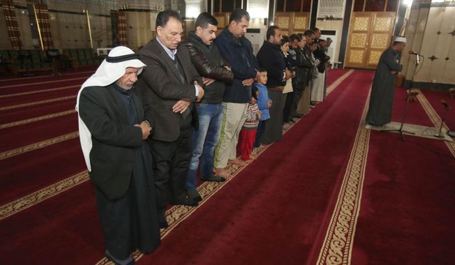 Iraqi Muslims pray at a mosque in Baghdad, Iraq, Tuesday, Dec. 8, 2015. (AP Photo/Karim Kadim)