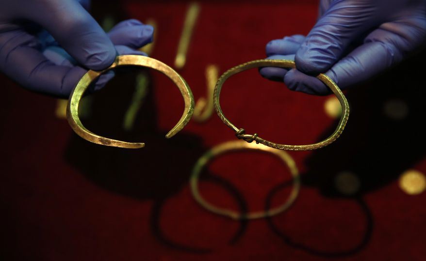 A close up of some of the jewellery and ingots of a significant Viking Hoard found near Watlington, in Oxfordshire, England as they are displayed at the British Museum in London, Thursday, Dec. 10, 2015. The hoard contains 186 coins, seven items of jewellery and 15 ingots of precious metal. The items include rare coins from era of King Alfred the Great (871-899) and King Ceolwulf II (874-79) when the kingdoms of Mercia and Wessex fought the invading 'Great Heathen Army' also known as the great Danish army, in the late 800's.(AP Photo/Alastair Grant)