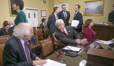 House Ways and Means Committee member Rep. Dave Reichert, R-Wash., center, confers with the committee&#39;s ranking member Rep. Sander Levin, D-Mich., on Capitol Hill in Washington, Thursday, Dec. 10, 2015, prior to going before the House Rules Committee as Congress works on legislation to avert a government shutdown when the funding runs out Friday night at midnight. White House and congressional negotiators are searching for compromise on huge tax and spending bills with a combined price tag of well over $1 trillion, with leaders hoping to clinch agreements and let Congress adjourn next week for the year. Ways and Means is the chief tax-writing committee in the House of Representatives. (AP Photo/J. Scott Applewhite) **FILE**