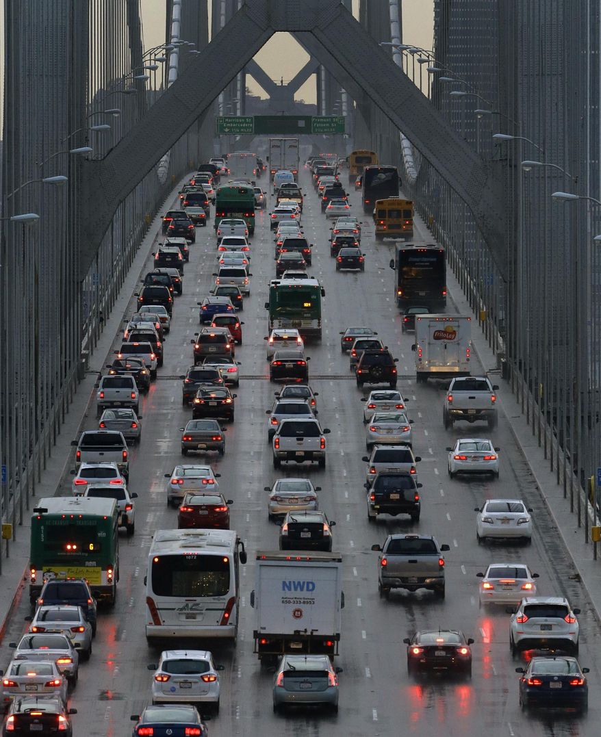 Vehicles make their way westbound on Interstate 80 across the San Francisco-Oakland Bay Bridge as a new series of rain storms bear down on the Bay Area Thursday, Dec. 10, 2015, as seen from Treasure Island in San Francisco. (AP Photo/Ben Margot)