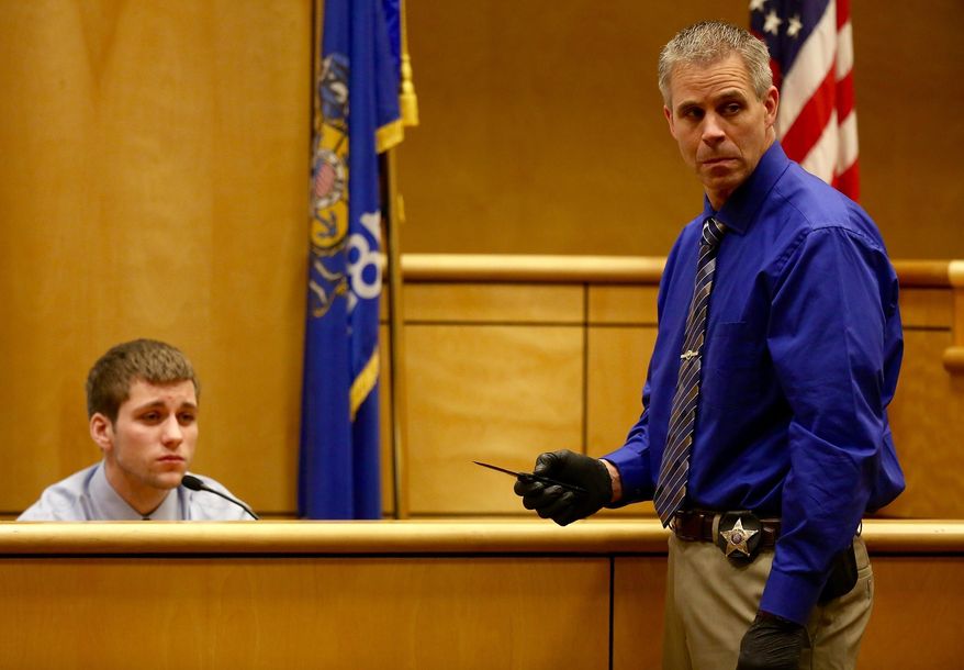 Investigator Rick Gearhart, the lead investigator with the Polk County sheriff's office shows the knife that Levi Acre-Kendall used to stab Peter Kelly as Acre-Kendall testifies in his trial Friday, Dec. 11, 2015, in Balsam Lake, Wis. Acre-Kendall is accused of fatally stabbing 34-year-old Peter Kelly of St. Croix Falls after an argument while fishing along the St. Croix River in April. (Leila Navidi/Star Tribune via AP) MANDATORY CREDIT; ST. PAUL PIONEER PRESS OUT; MAGS OUT; TWIN CITIES LOCAL TELEVISION OUT