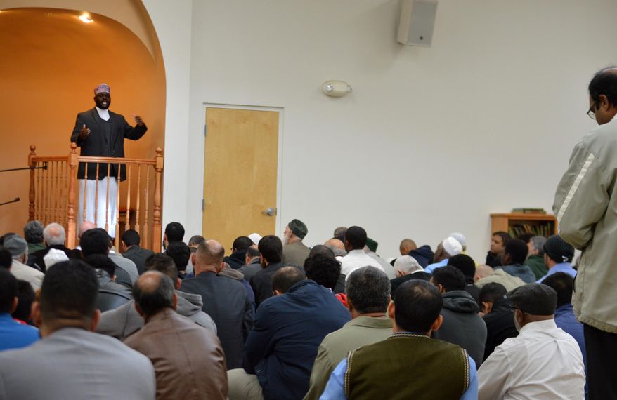 Imam Shafi Abdul Aziz, left, of the the Islamic Center of New Mexico in Albuquerque, speaks on the importance of tolerance during afternoon prayer Friday, Dec. 11, 2015. A coalition of Christian and Jewish leaders presented the Albuquerque mosque dozens of "letters of support" after GOP presidential hopeful Donald Trump suggested the U.S. place a moratorium on Muslim immigration. (AP Photo/Russell Contreras)