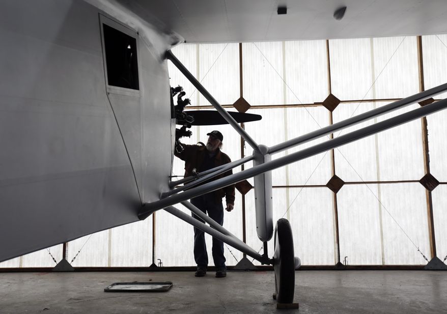 In this Sunday, Dec. 6, 2015 photo, pilot Ken Cassens readies a Spirit of St. Louis replica for flight at the Old Rhinebeck Aerodrome in Rhinebeck, N.Y. Cassens has spent years creating a doppelganger of the plane Charles Lindbergh flew across the Atlantic in 1927 down to every flap and fuel gauge. (AP Photo/Mike Groll)