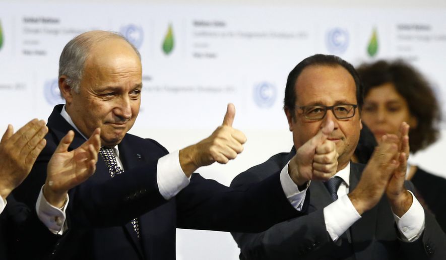 French President Francois Hollande, right, and French Foreign Minister and president of the COP21 Laurent Fabius react after the final conference at the COP21, the United Nations conference on climate change, in Le Bourget, north of Paris, Saturday, Dec. 12, 2015. Governments have adopted a global agreement that for the first time asks all countries to reduce or rein in their greenhouse gas emissions. (AP Photo/Francois Mori)