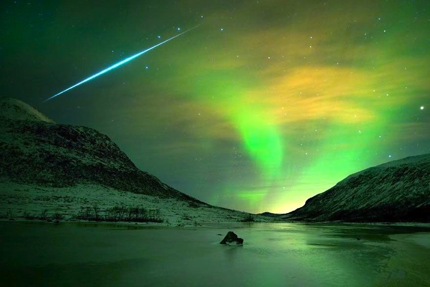 The Geminid meteor shower will peak on Sunday night; here's a previous display as a single meteoroite streaks across the aurora borealis in Norway. (Image courtesy of NASA)