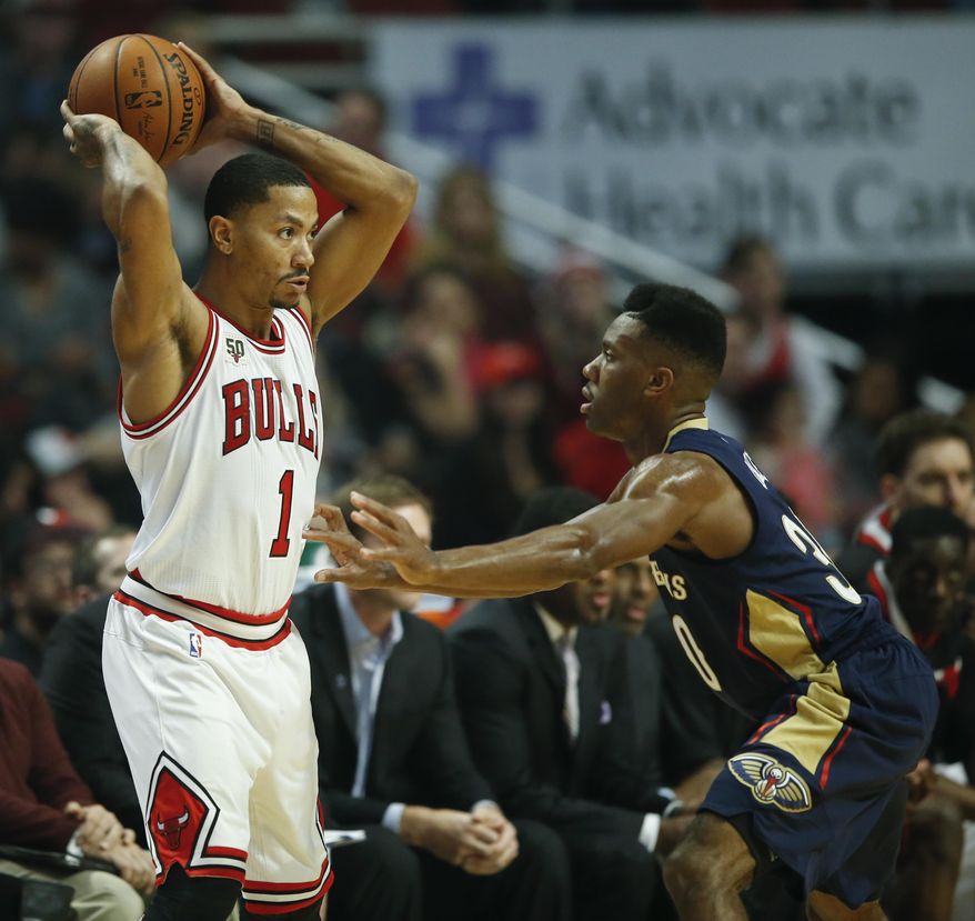 Chicago Bulls guard Derrick Rose (1) looks to pass the ball against New Orleans Pelicans guard Norris Cole during the first half of an NBA basketball game, Saturday, Dec. 12, 2015, in Chicago. (AP Photo/Kamil Krzaczynski)