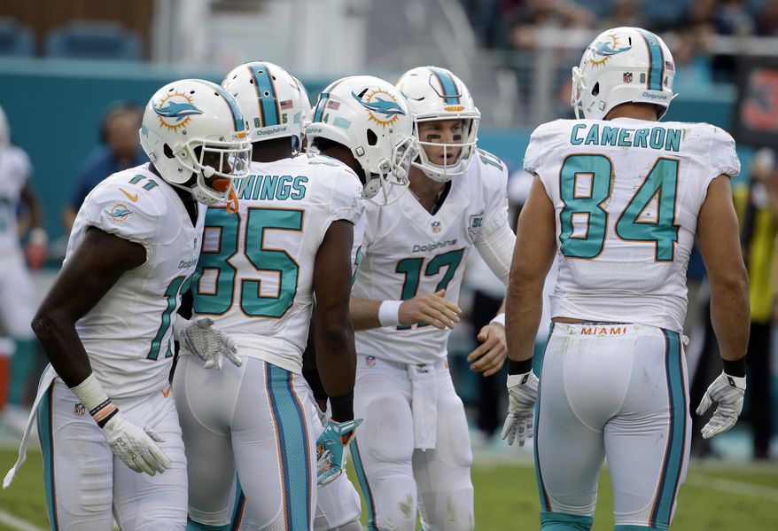FILE - In this Dec. 6, 2015, file photo, Miami Dolphins quarterback Ryan Tannehill (17) huddles with the offensive during the first half of an NFL football game against the Baltimore Ravens in Miami Gardens, Fla. Tannehill is coming off one of his least productive games and adjusting to yet another play-caller for the Dolphins as they prepare to face the New York Giants on Monday, Dec. 14, 2015, whose pass defense ranks last in the NFL. (AP Photo/Lynne Sladky, File)