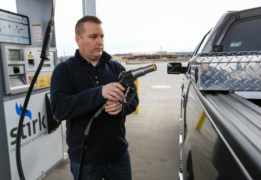 Mike Hoelsher fuels a pickup truck with compressed natural gas in Lincoln, Neb., Friday, Dec. 11, 2015. Cars and trucks that run on this fuel could be able to cross Nebraska and travel the state much more extensively with a new fueling station that’s set for construction next year. The expected station in North Platte, Neb., would close a major gap on Interstate 80 and allow more vehicles to make the trip from Omaha and Lincoln to Cheyenne and Denver. (AP Photo/Nati Harnik)