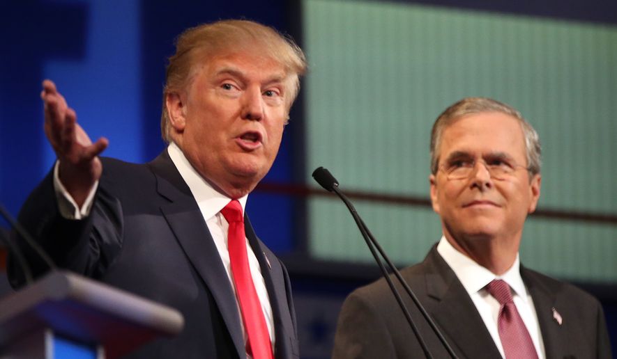 Republican presidential candidates Donald Trump and Jeb Bush participate in the first Republican presidential debate at the Quicken Loans Arena in Cleveland on Aug. 6, 2015. (Associated Press) **FILE**