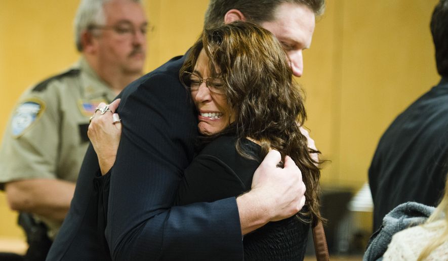 Lavonne Acre, mother of Levi Acre-Kendall, embraces defense attorney Doug Hazelton after the verdict acquitting Levi Acre-Kendall of all three charges of reckless and intentional homicide in the stabbing of a Wisconsin fisherman, on Monday, Dec. 14, 2015, at the Polk County Court in Balsam Lake, Wisc. (Mark Vancleave/Star Tribune via AP) MANDATORY CREDIT; ST. PAUL PIONEER PRESS OUT; MAGS OUT; TWIN CITIES LOCAL TELEVISION OUT