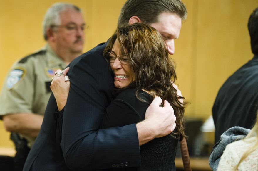 Lavonne Acre, mother of Levi Acre-Kendall, embraces defense attorney Doug Hazelton after the verdict acquitting Levi Acre-Kendall of all three charges of reckless and intentional homicide in the stabbing of a Wisconsin fisherman, on Monday, Dec. 14, 2015, at the Polk County Court in Balsam Lake, Wisc. (Mark Vancleave/Star Tribune via AP) MANDATORY CREDIT; ST. PAUL PIONEER PRESS OUT; MAGS OUT; TWIN CITIES LOCAL TELEVISION OUT