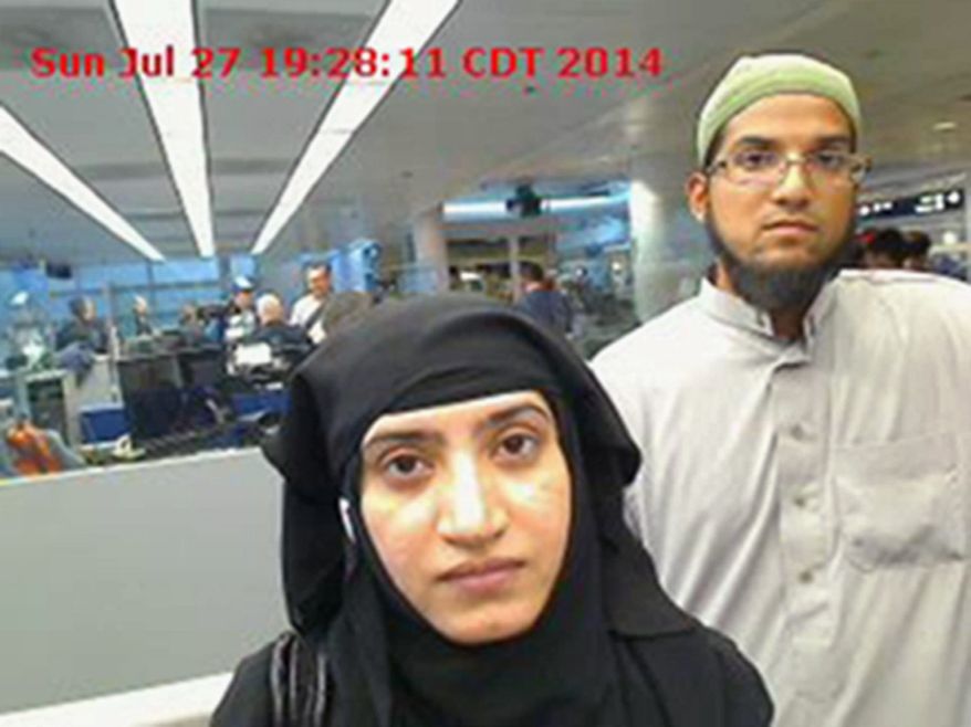 This July 27, 2014 photo provided by U.S. Customs and Border Protection shows Tashfeen Malik, left, and Syed Farook, as they passed through O'Hare International Airport in Chicago. (Associated Press)