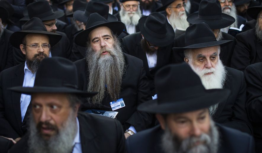 Lubavitch rabbis who were among a gathering of thousands of Orthodox rabbis from 86 countries wait for their group photo to be taken near Chabad-Lubavitch headquarters in the Brooklyn borough of New York, Sunday, Nov. 8, 2015. The group is in New York for the International Conference of Chabad-Lubavitch Emissaries, an annual event aimed at reviving Jewish awareness and practice around the world. (AP Photo/Andres Kudacki)