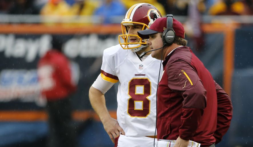 Washington Redskins head coach Jay Gruden talks to quarterback Kirk Cousins (8) during the second half of an NFL football game against the Chicago Bears, Sunday, Dec. 13, 2015, in Chicago. (AP Photo/Charles Rex Arbogast)

