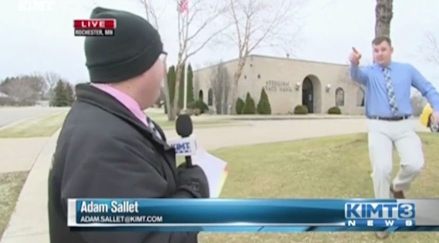 KIMT-TV reporter Adam Sallet was doing a live update Tuesday on a Minnesota bank robbery, when he spotted the suspect running away after allegedly trying to rob the bank a second time. (KIMT-TV)