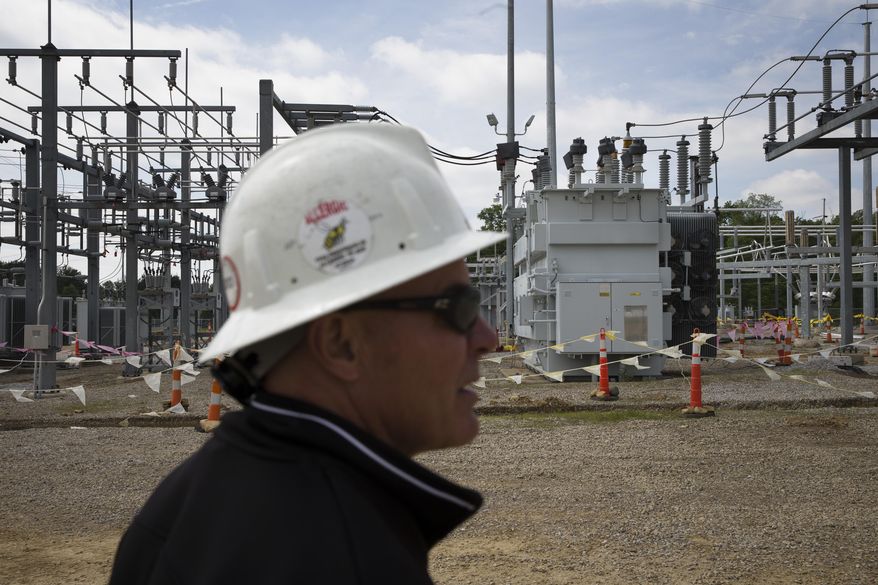 In this Wednesday, May 20, 2015, file photo, Christian Vittorio, an AEP transmission field coordinator, gives a tour of an AEP electrical transmission substation in Westerville, Ohio. (AP Photo/John Minchillo) ** FILE **