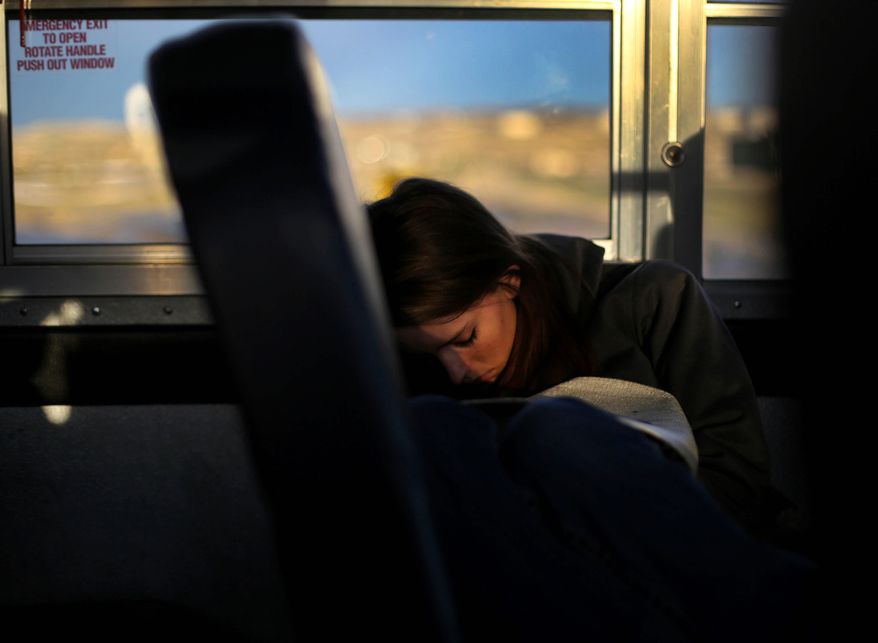 ADVANCE FOR THE WEEKEND OF DEC. 19-20 - In this Tuesday, Dec. 8, 2015 photo, Kelly Walsh High School student Victoria Nichols naps after transferring to a second bus during her two-hour ride to school early morning in Natrona County, Wyoming. Victoria, 15, has one of the the longest commutes of any student in Natrona County School District, where buses logged more than a million miles last year. (Dan Cepeda/The Casper Star-Tribune via AP) MANDATORY CREDIT