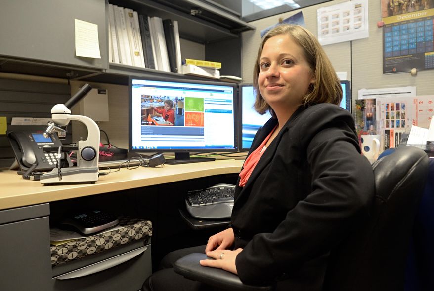 In this Dec. 8, 2015, photo, Gabrielle Holcomb, a participant in Sandia National Labs' Wounded Warrior Career Development program, poses for a photo. A decade after surviving three brain-rattling explosions and a close encounter with a mortar round that failed to detonate, Iraq war veteran Holcomb is still serving her country – this time by protecting Sandia National Laboratories from counterfeit products ranging from cellphone chargers to weapons parts. (Dean Hanson/The Albuquerque Journal via AP) MANDATORY CREDIT