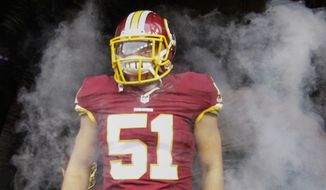 Washington Redskins inside linebacker Will Compton (51) stands in the smoke waiting for his introduction before an NFL football game against the New York Giants in Landover, Md., Sunday, Nov. 29, 2015. (AP Photo/Mark Tenally)