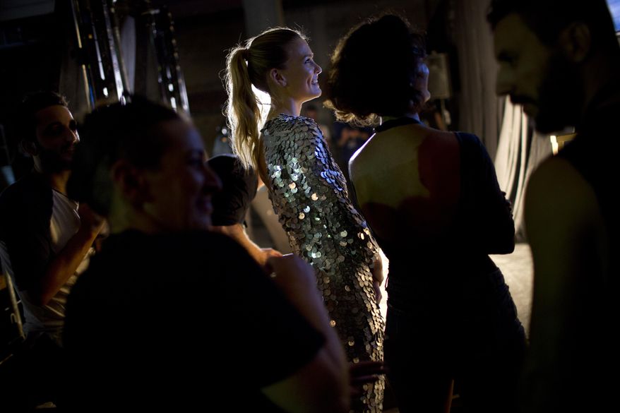 FILE - In this Sunday, Oct. 18, 2015 file photo, Israeli model Bar Refaeli waits before walks on the runway during the opening night of Fashion Week in Tel Aviv, Israel. Israel's tax authority said Thursday, Dec. 17, 2015 that the international supermodel and her mother are suspected of tax evasion for allegedly not reporting millions of dollars in income earned abroad and on luxury items.(AP Photo/Oded Balilty, File)