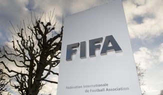The FIFA logo is pictured outside the FIFA headquarters in Zurich, Switzerland, Thursday, Dec. 17, 2015. While FIFA President Sepp Blatter will appear in person on Thursday before the panel of four judges of the FIFA ethics court, UEFA President Michel Platini plans to boycott his hearing on Friday Dec. 18. Blatter and Platini were banned for 90 days for all activities in football. (Walter Bieri/Keystone via AP)
