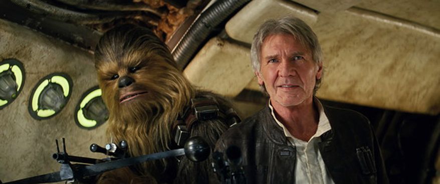 This photo provided by Lucasfilm shows Peter Mayhew as Chewbacca and Harrison Ford as Han Solo in "Star Wars: The Force Awakens," directed by J.J. Abrams. Lawrence Kasdan co-wrote the screenplay with Abrams. The movie opens in U.S. theaters on Friday, Dec. 18, 2015. (Film Frame/Lucasfilm via AP) -