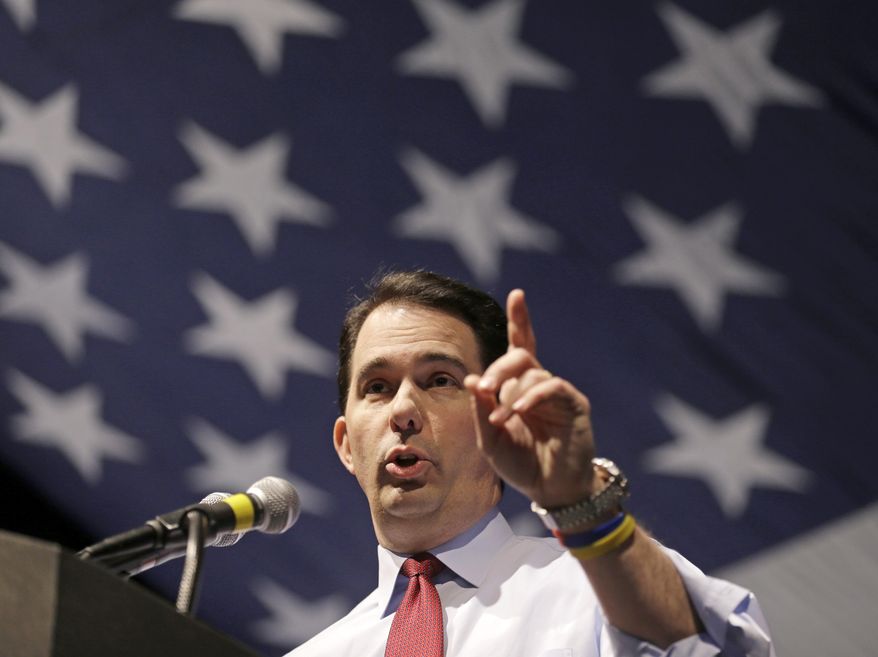 FILE - In this May 3, 2014 file photo, Wisconsin Gov. Scott Walker speaks at the Republican party of Wisconsin State Convention in Milwaukee. Advocates on all sides of the debate about how political money should be regulated are watching Wisconsin, where bills signed into law this week are expected to allow a freer flow of cash with fewer reporting requirements. (AP Photo/Jeffrey Phelps, File)