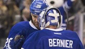 Toronto Maple Leafs&#39; Daniel Winnik hands goaltender Jonathan Bernier the game puck after he shut out Los Angeles Kings in a 5-0 Maple Leafs win in an NHL hockey game Saturday, Dec. 19 2015, in Toronto, (Chris Young/The Canadian Press via AP)