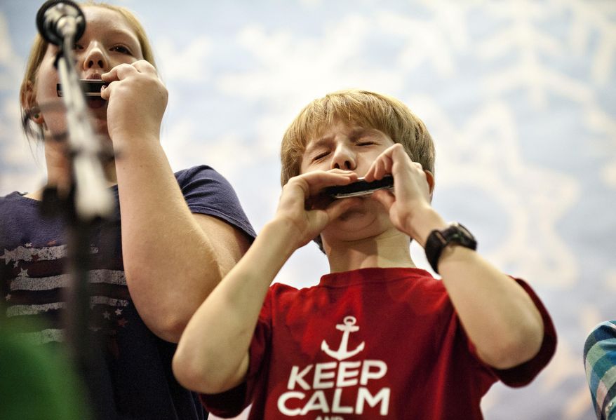 Lucas Huff, 11, plays the harmonica with the his fifth grade class with the Kentucky Blues Society on Wednesday, Dec. 16, 2015, at W.R. McNeill Elementary School in Bowling Green, Ky. In a visit coordinated through the Southern Kentucky Performing Arts Center, representatives from the Kentucky Blues Society taught fifth-graders at McNeill Elementary School about the blues. (Miranda Pederson/Daily News via AP) MANDATORY CREDIT
