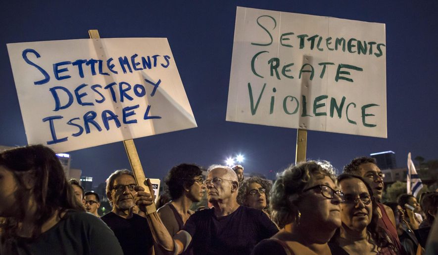 FILE - In this Saturday, Aug. 1, 2015 file photo, Israeli members of the gay community and peace activists rally, call for an end to violence, in Tel Aviv, Israel. Organizations critical of Israeli policy toward Palestinians say they are facing a crackdown by the government and hardline organizations amid a wave of renewed bloodshed in the Holy Land. (AP Photo/Tsafrir Abayov, File)