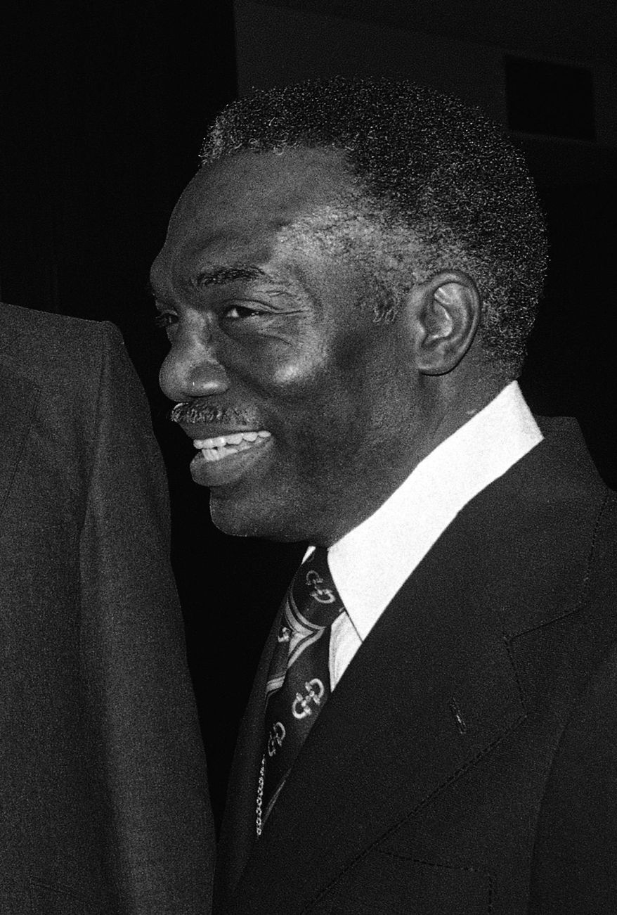 FILE - In this Saturday, March 10, 1979 file photo, President of Fisk University Walter Leonard congratulates John Hope Franklin of the University of Chicago during a ceremony in Chicago. Leonard, a man who designed an admissions process at Harvard University that led to more minority students being admitted, died at 86 of complications from Alzheimer's disease earlier in December 2015, his wife Betty Leonard said. (AP Photo)