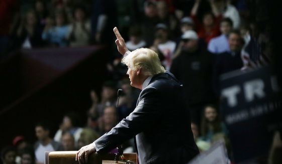 Republican presidential candidate Donald Trump addresses supporters at a campaign rally, Monday, Dec. 21, 2015, in Grand Rapids, Mich. (AP Photo/Carlos Osorio)