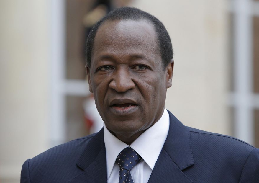 FILE - In this Tuesday, Sept, 18, 2012 file photo, Burkina Faso's president Blaise Compaore speaks to the media after a meeting with France's President Francois Hollande in Paris. Burkina Faso's military court has issued an international arrest warrant for former President Blaise Compaore for the assassination of the country's ex-revolutionary leader Thomas Sankara, the tribunal director said Monday, Dec. 21, 2015. Sankara was killed along with 12 of his supporters during a 1987 bloody coup that brought Compaore to power. (AP Photo/Francois Mori, File)