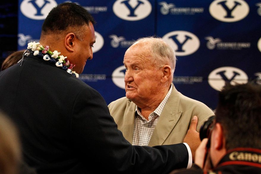 Former BYU head coach LaVell Edwards greets Kalani Sitake after Sitake was introduced as the new football head coach for Brigham Young University during a news conference, Monday, Dec. 21, 2015 at the BYU Broadcasting Building in Provo, Utah. (Sammy Jo Hester/The Daily Herald via AP) MANDATORY CREDIT