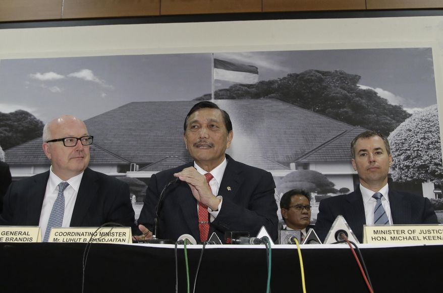 Indonesian top security minister Luhut Panjaitan, center, talks to the media as Australia's Attorney General George Brandis, left, and Justice Minister Michael Keenan, right, listen during a joint press conference after their meeting in Jakarta, Indonesia, Monday, Dec. 21, 2015. Indonesian police say they have foiled a suspected Muslim militant’s plot to carry out attacks during the year-end holiday season with help from the information from the U.S., Australian and Singaporean intelligence. (AP Photo/Achmad Ibrahim)